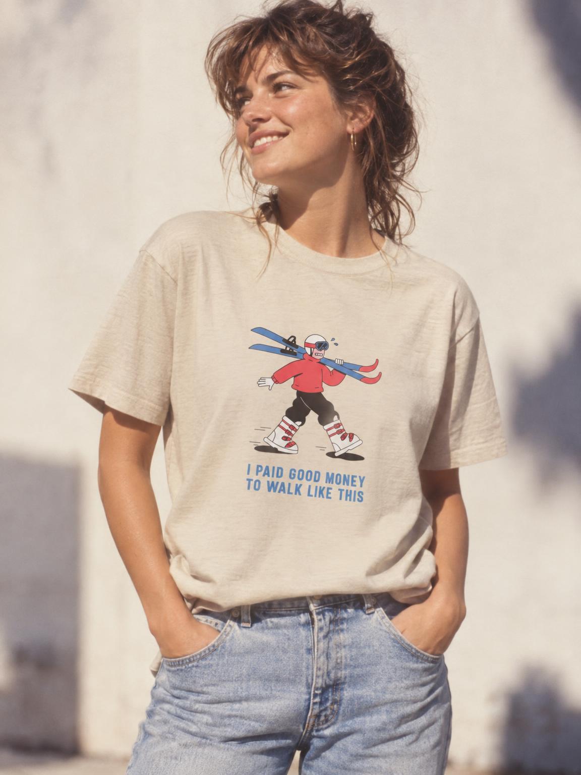 Skiing I Paid Good Money To Walk Like This Funny Ski T-Shirt in Sand – worn by a woman