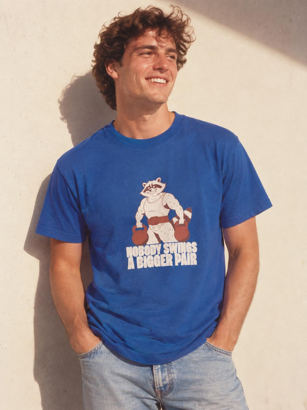 Bulking Season Kettlebell Raccoon Funny Gym Humor T-Shirt in Royal – worn by a man