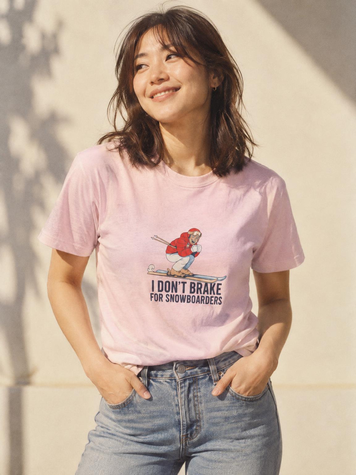 Skier Gift I Don't Brake For Snowboarders Funny Skiing T-Shirt in Light Pink – worn by a woman