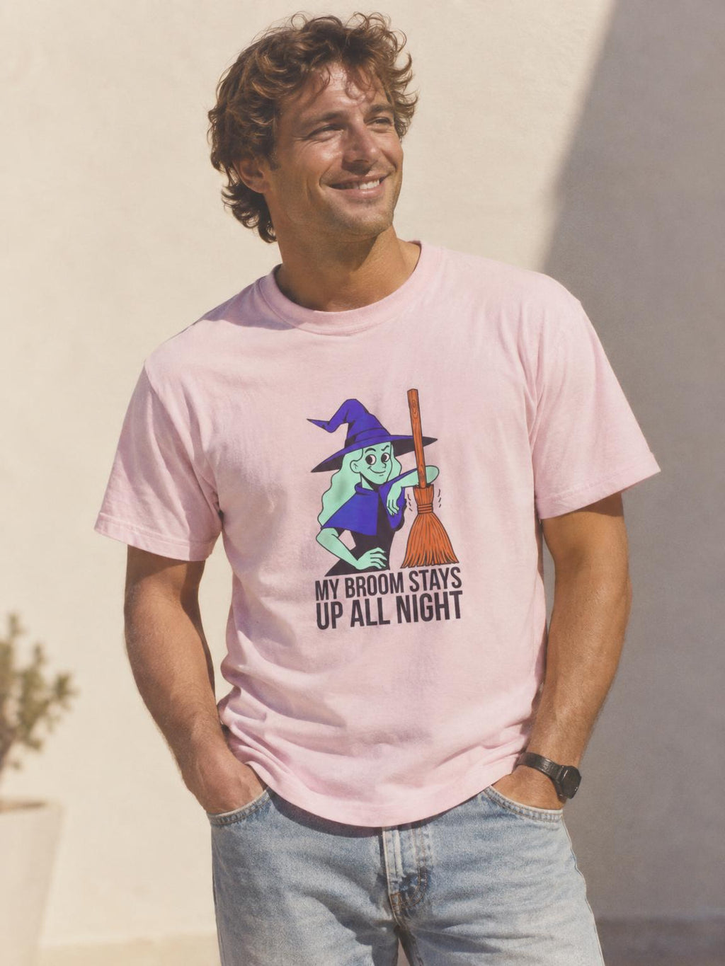 Funny Witch Broom Halloween Adult Humor T-Shirt in Light Pink – worn by a man